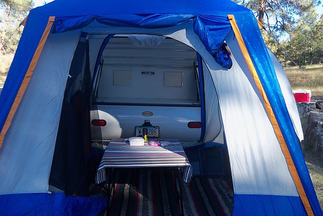 Rain fly of SUV tent rolled up to expose door. Very Cozy indeed..jpg