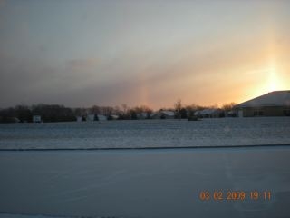 Sun set with a rainbow on the left