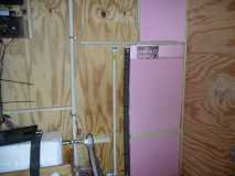 Insulating water pipes and wall between bathroom & kitchen.