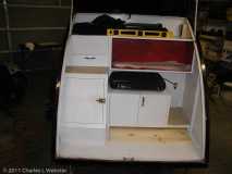 Galley with counter top stowed below lower cabinet