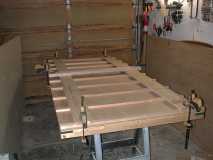 clamping down the glued ribs to the plywood
