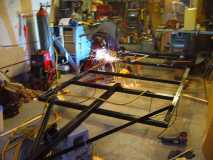 Welding the axle hangers to frame in my tiny garage