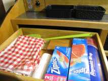 Upper galley drawer filled with camping gear - IMG 2592