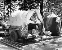 August 1953, near Shasta Lake, Shasta National Forest, California, USA. Monon and Ottily Bayer, the daughters of Mr. and Mrs. Otto Bayer of Costamesa, California, in a small, bunk bed trailer at their campground i