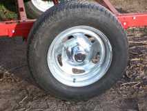 (0004) I didn't like the small 12" wheels & tires. These are the new ones I got on Ebay for $41 each with S&H. They are galvanized 14" by 5 1/2" trailer wheels 5 by 4 1/2" bolt pattern.